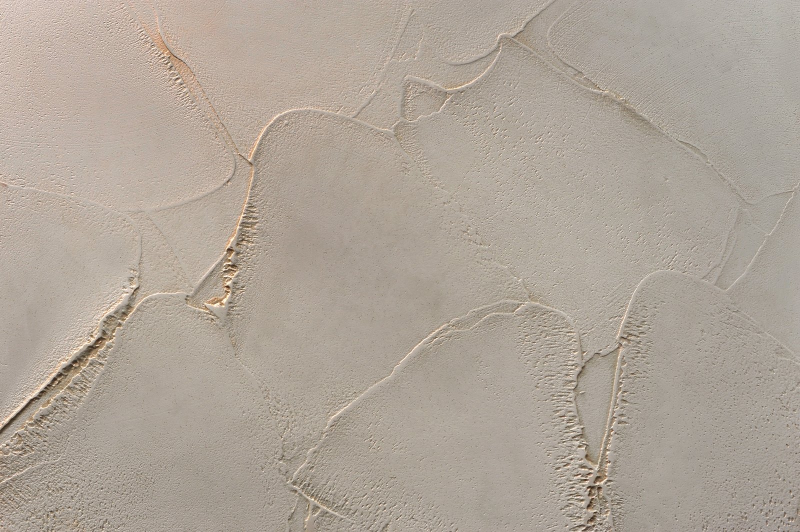 Decorative Venetian plaster with a texture molded with a spatula, plastic surface with gold, a play of light and shadow